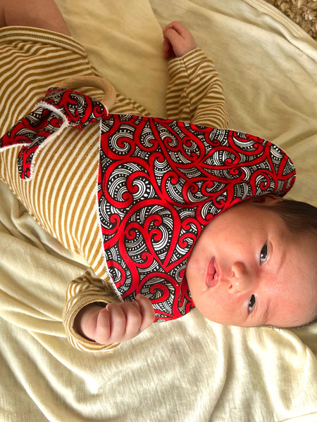 Māori Inspired Koru Design Red Bib and Red Teether by Māori Fashion Designer Adrienne Whitewood.