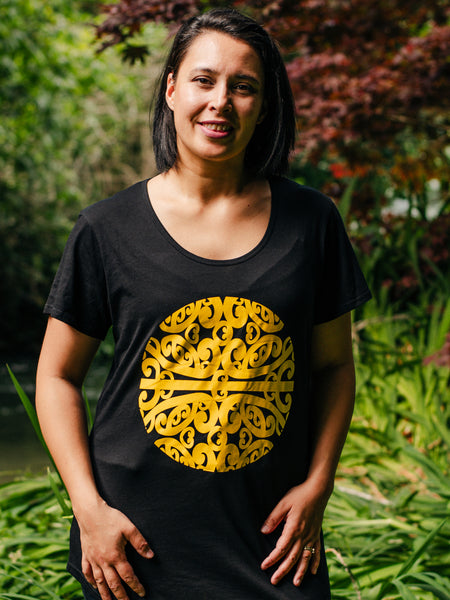 Māori Inspired Yellow Koru Design Tee in Black representing Mahina our Māori Moon story from our Māori Gods. Talking about the new moon new year new beginnings. Designed by Māori Fashion Designer Adrienne Whitewood.
